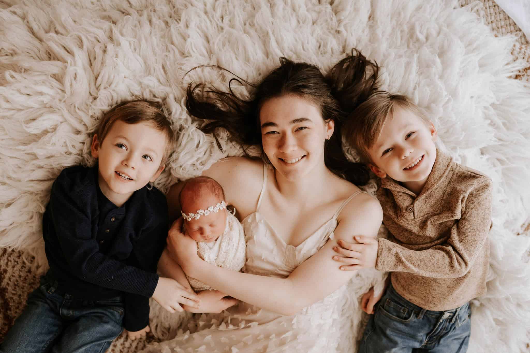 Arabella being held by sister and two brothers