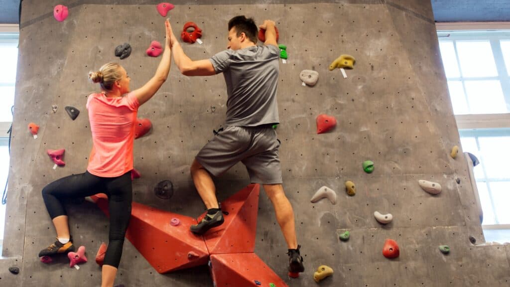 two teenagers on a climbing wall