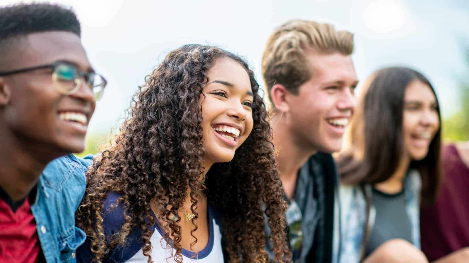 a smiling group of four young people