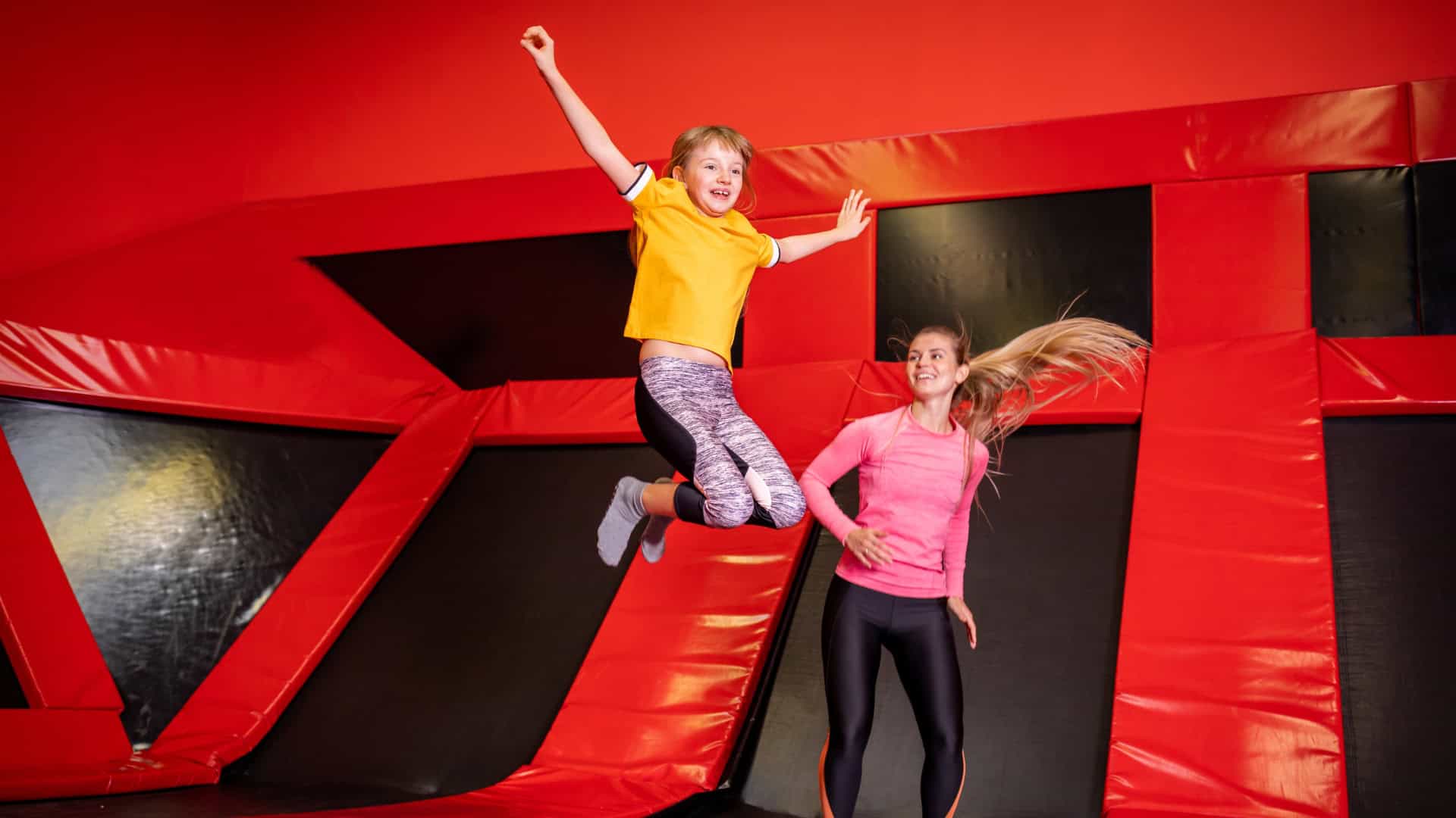 two young people jumping at Sky Zone